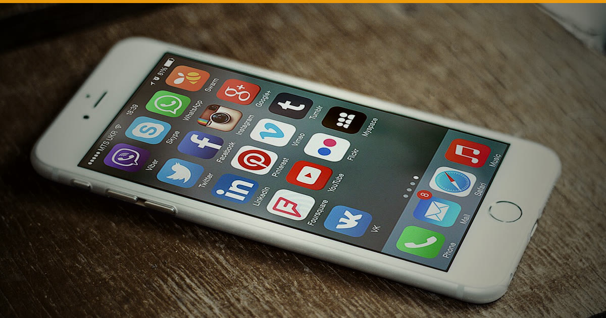 Phone and laptop showing social media icons